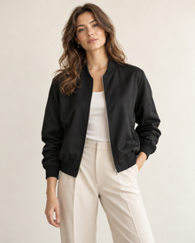 Woman wearing Maison Elin minimal bomber jacket in black